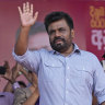 Anura Kumara Dissanayake waves to supporters during a public rally in Dehiowita.