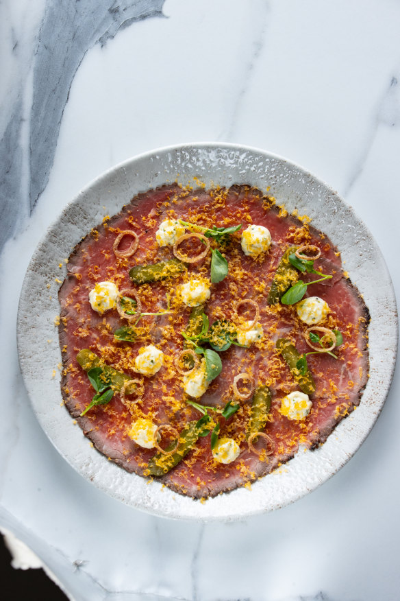 Beef carpaccio with horseradish crème fraiche, fried shallots and grated smoked egg yolk. 