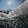 The sun shines over the melting Rhone Glacier near Goms, Switzerland