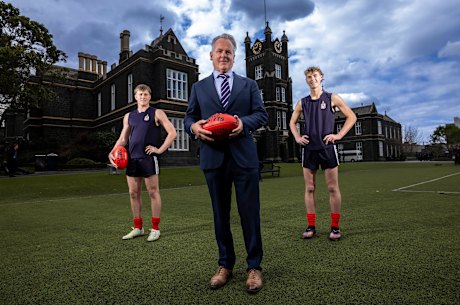 Melbourne Grammar deputy headmaster Ben Hanisch with football-playing students Toby Callaghan, Year 11 and Toby Hellessey, Year 10.