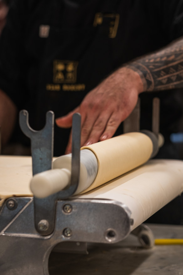 Laminating pastry for croissants.