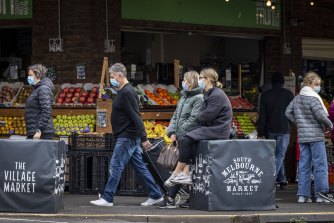 Masks remained on at South Melbourne Market on Sunday.