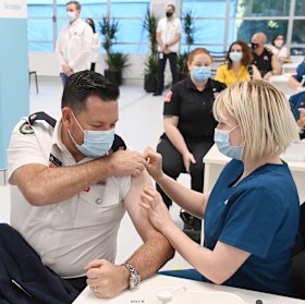 Ben Shepherd from the Rural Fire Service receives his COVID-19 vaccine at the Olympic Park Vaccination Centre.