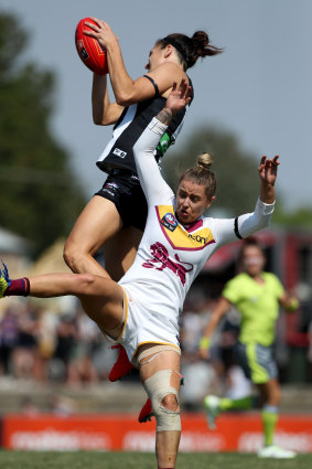 Collingwood's Ash Brazill flies for a mark in the 2019 AFLW season.