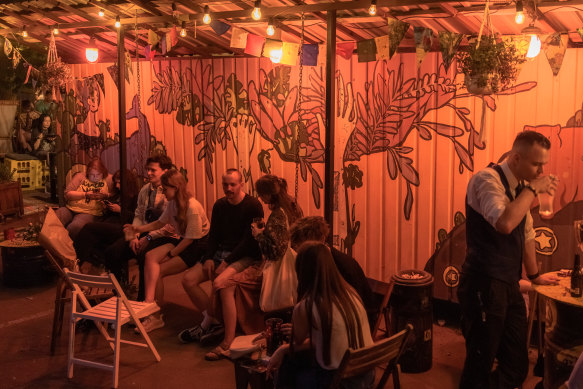 People enjoying a night out at a bar in Kyiv.