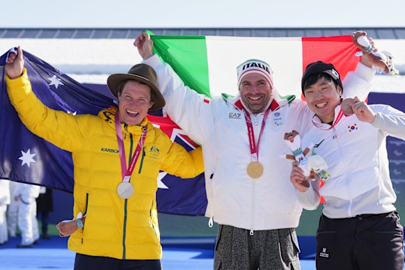 Silver medallist Ben Tudhope, of Australia, gold medallist Emanuel Perathoner of Italy and bronze medallist Lee Jehyuk of South Korea, pose with their medals after the men’s snowboard cross SB-LL2.
