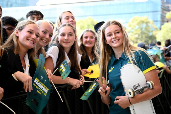 Ruby Trew poses for a photo with schoolchildren at Tumbalong Park on Friday.