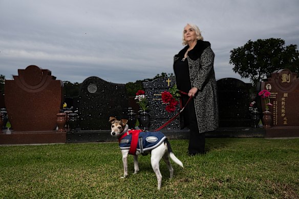 Carmen Terceiro visiting her father’s grave with her eight-year-old Jack Russell, Milo.