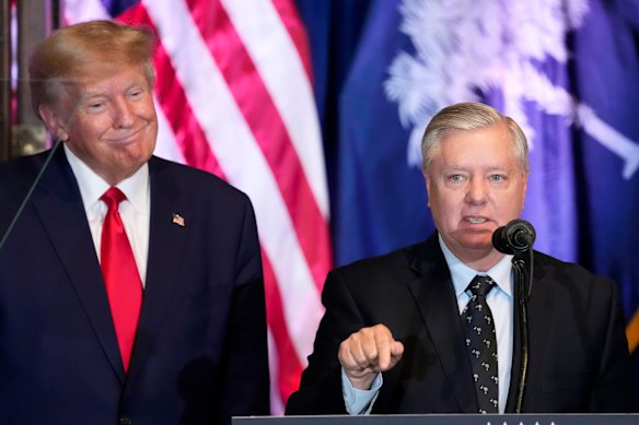 Donald Trump listens to Lindsey Graham speak at a campaign event in South Carolina in 2023.
