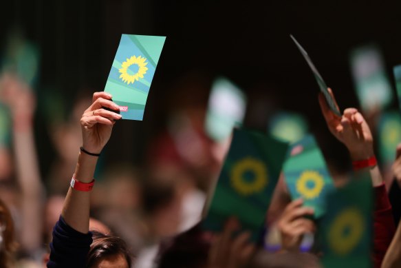Federal delegates hold up their voting cards during the German Greens party federal congress in Bonn, Germany. 