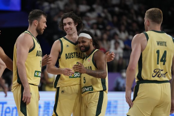 Boomers stars Josh Giddey (3) and Patty Mills (5) share a moment in their team’s win over Georgia.