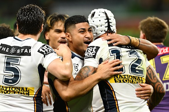 Josiah Karapani (centre) celebrates a try with Broncos teammates during their comeback round-three win against the Storm last week.