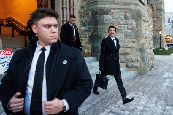 Prime Minister Justin Trudeau (right) leaves his office on Parliament Hill in Ottawa on Friday.