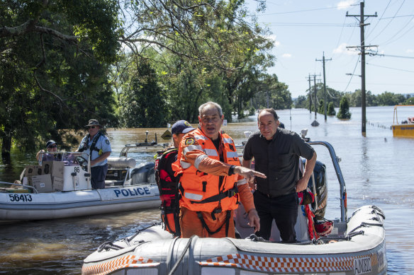 Police and SES volunteers transporting goods to isolated people in Windsor.