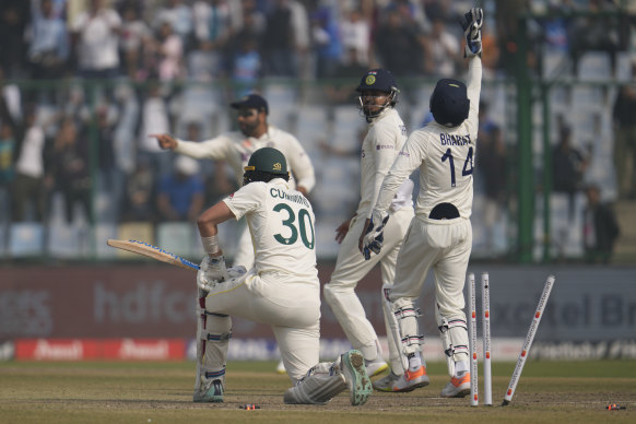 Indian players celebrate the dismissal of Australia’s Pat Cummins.