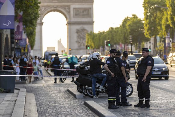 Police stands guard near Louis Vuitton store after a police officer was injured in an attack in the Champs Elysees shopping district in Paris, France. 