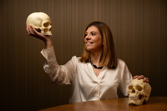Dr Eline Schotmans holding a replica of a neolithic human skull.