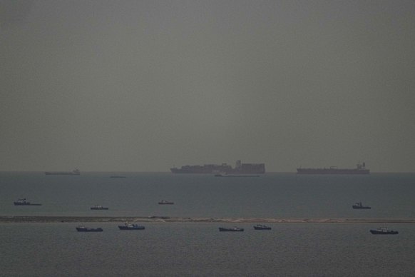 Fishing boats (foreground) and cargo ships in the Persian Gulf near the Strait of Hormuz.