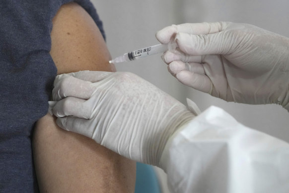 A medical worker gives a shot of Pfizer COVID-19 vaccine.
