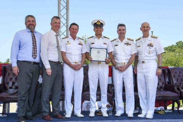 Admiral James Caldwell jnr, director of the Naval Nuclear Propulsion Program (right); Royal Australian Navy Vice Admiral Jonathan Mead; RAN chief Mark Hammond; Erik Raven, Under-Secretary of the Navy; and Abraham Denmark, senior adviser to the Secretary of Defence for AUKUS, pose for a photo with graduate James Heydon.