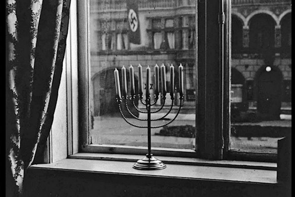 A 1931 photograph of a Jewish menorah on a window ledge in Nazi Germany. 