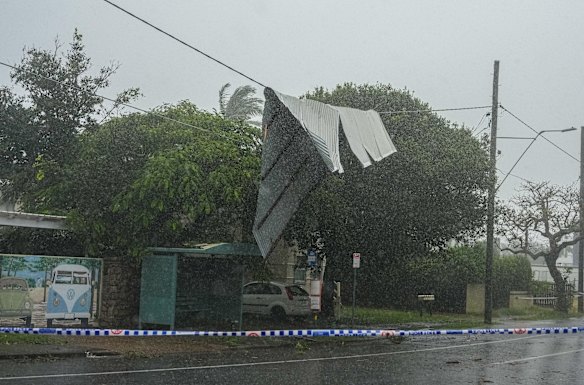 A tin roof hangs on a powerline on in Brisbane amid the cyclone.