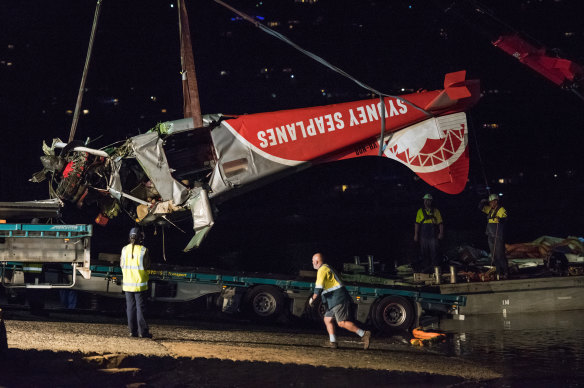 The wreck of the crashed seaplane is pulled from the water in January 2018. 