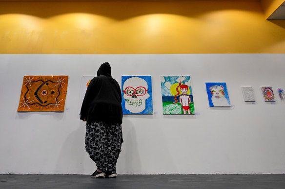 A user of the safe injecting room views the exhibition, which includes her work, at the Hive Shopping Centre in Abbotsford. 