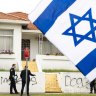 The flag of Israel, raised in solidarity with Jewish Australians, billows in front of a house in the Sydney suburb of Maroubra which was attacked with antisemitic graffiti on Thursday. 