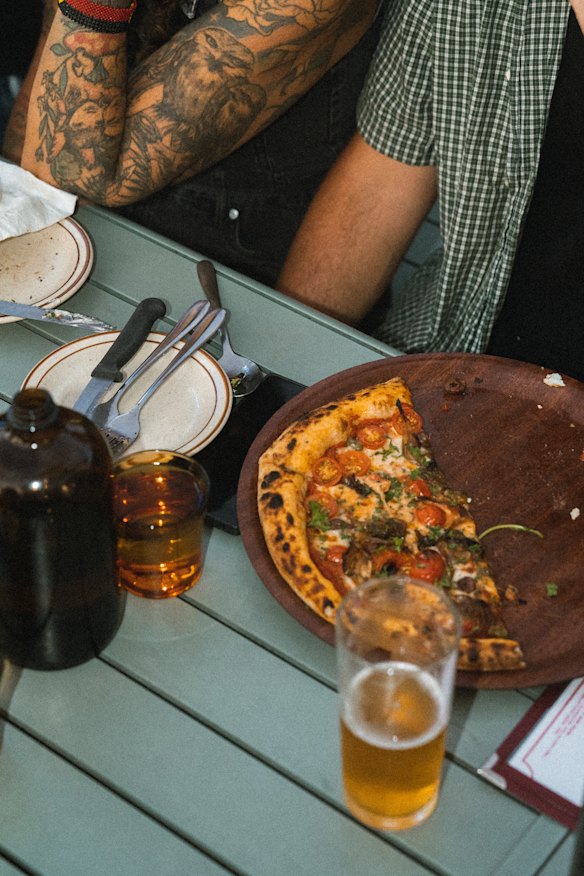 The menu includes wood-fired pizzas, salads and starters. 