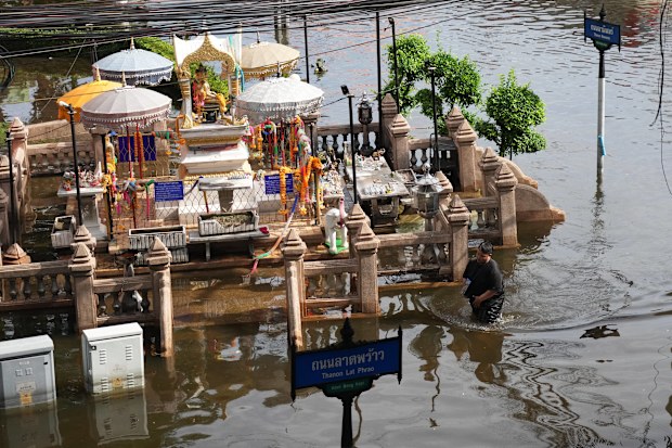 A man wades through floodwaters after heavy rain in Bangkok, Thailand, Tuesday, Sept. 29, 2026