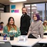 Principal Charles Hertzog with students Raghad Jafari and Gulsum Saiahi at River Nile School.