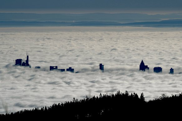 The buildings of the banking district come out of the thick fog over Frankfurt.