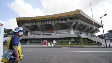 A volunteer works outside the Nippon Budokan stadium for judo ahead of the 2020 Summer Olympics.