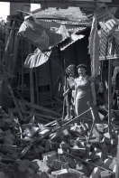 “A direct hit destroyed the rear part of this home in the eastern suburbs, but the occupants, inspecting the twisted wreckage when daylight came, remained cheerful”