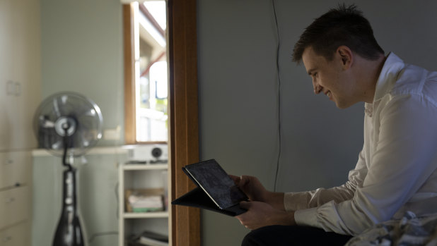 Declan Clarke speaks to his fiance in Russia via Facetime in his bedroom at home.