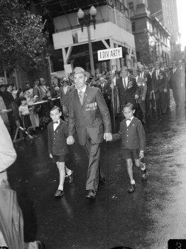 “Two small boys marched with their father under the banner of the First Machine-gun-Battalion.”