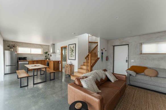 Inside, the grey polished floors could use another rug but are balanced by warm timber accents.