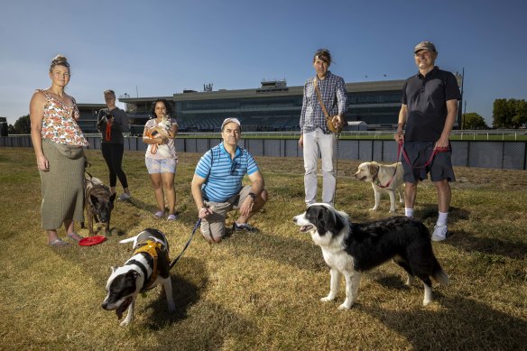 Anaru August with dog Baxter and other Caulfield dog-walking locals concerned about what Melbourne Football Club’s shift to the racecourse will mean for public use.