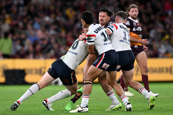 Jesse Arthars is tackled during the Broncos’ defeat to the Roosters.