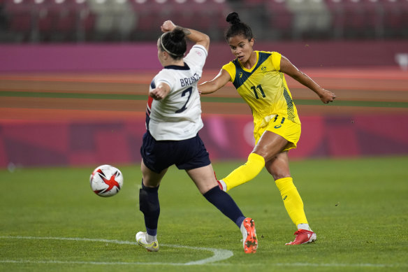 Fowler beats Lucy Bronze to score against Great Britain at the Olympics.