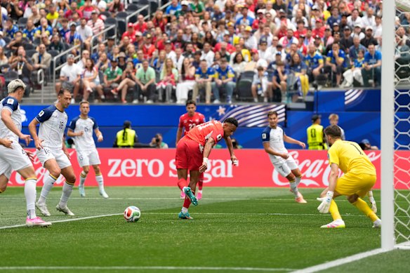 Switzerland’s Dan Ndoye, center, tries reach the ball in front of Bosnia goalkeeper Nikola Vasilj.