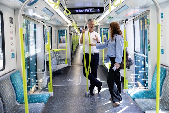 John Graham and Alexandra Smith ride the metro. 