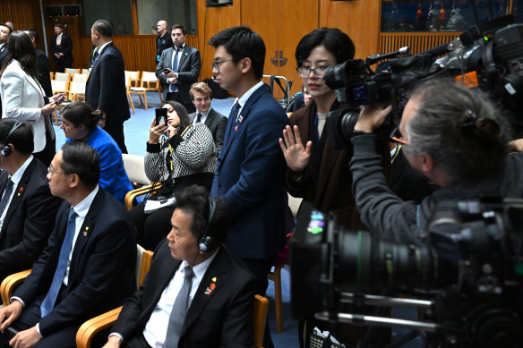 Chinese officials try to block cameras from filming Chinese-born Australian journalist Cheng Lei (covered).