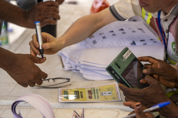 A voter’s finger is marked at a polling station in Lagos, Nigeria on Saturday.