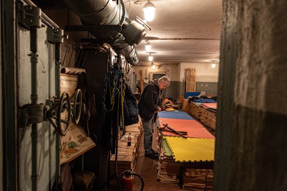 A civilian member of a Territorial Defence unit rests in a bomb shelter in Kyiv, Ukraine. 