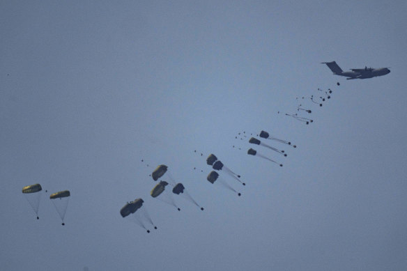 An aircraft airdrops humanitarian aid over Gaza the northern Gaza Strip.