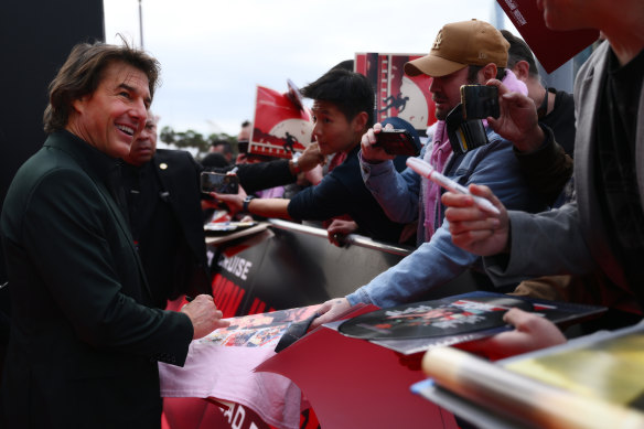 Tom Cruise poses with fans during the Australian premiere of Mission: Impossible – Dead Reckoning Part One.