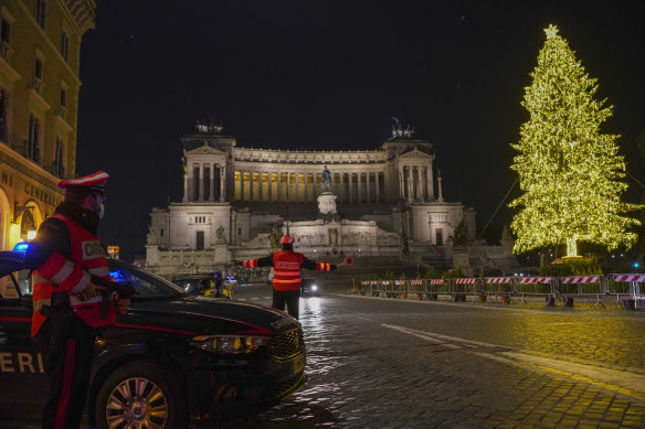 The normally bustling Piazza Venezia is deserted on New Year’s eve 2020, bar Carabinieri police officers, during lockdown restrictions.