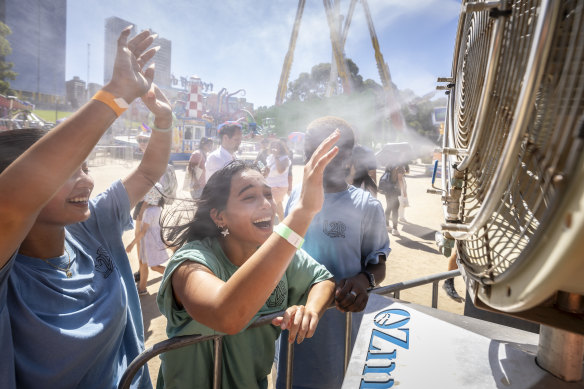 Onlookers cool down to enjoy the Moomba festivities on Sunday.